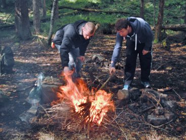 Stoking the fire on Bushcraft Course